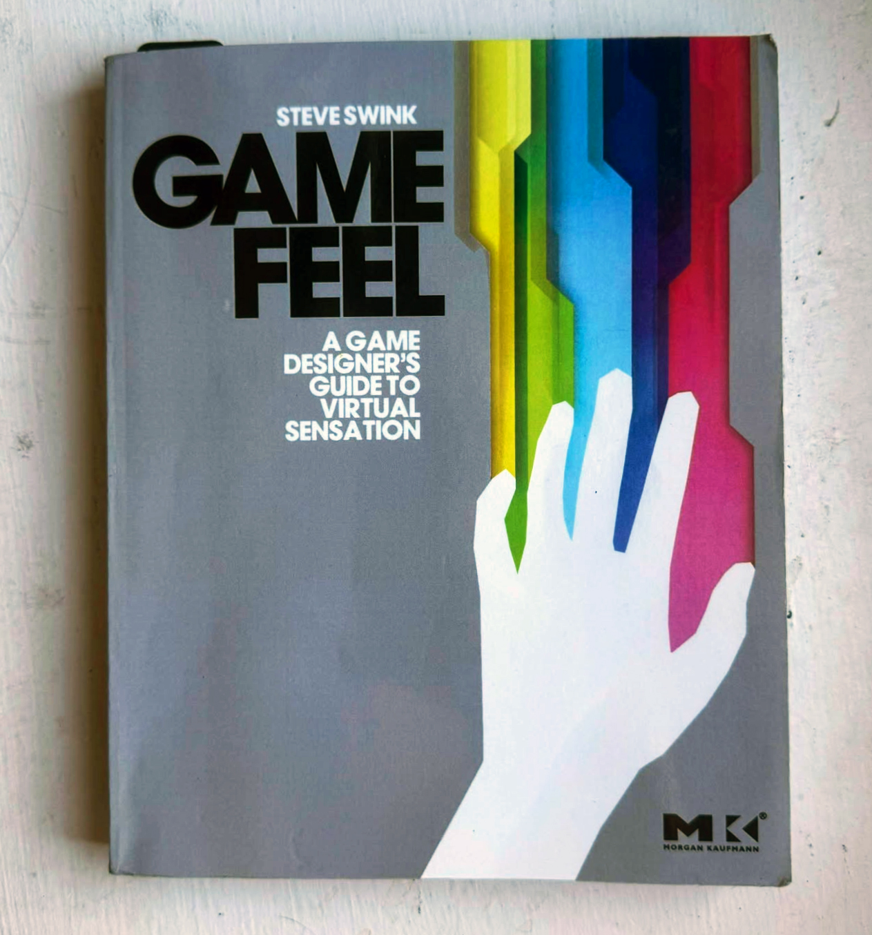 An image of the book GAME FEEL: A Game Designer's Guide to a Virtual Sensation by Steve Swink.